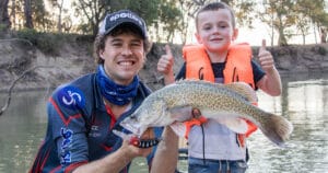 Rhys at Nagambie Lakes with a young boy and a Murray Cod